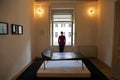 Girl standing with her back at window at psychoanalysis couch in Sigmund Freud museum in Vienna