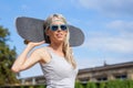 Girl standing and holding skateboard behind her head Royalty Free Stock Photo