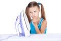 Girl standing and looking at iron at home.