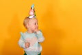 A girl is standing in a multi-colored sweater, waving her arms around the sides in a wig Royalty Free Stock Photo