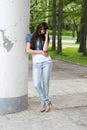 Girl standing near column