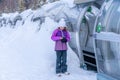 A girl standing near magicagic carpet ski lift in a glass tunel. Snowy winter day in the french ski resort.