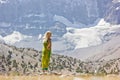 Girl standing near the mountain lake