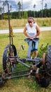 Girl standing at the old agricultural equipment Royalty Free Stock Photo