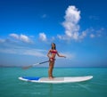 Girl standing on paddle surf board SUP Royalty Free Stock Photo