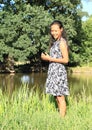 Girl standing by pond Royalty Free Stock Photo