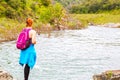 Girl Standing on Rocks Near Fast River
