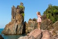 Girl standing among the rocks on the sea coast. Royalty Free Stock Photo