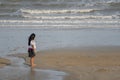 A girl standing at the sea on Chao Samran beach, Phetchaburi, Thailand