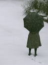A girl standing in snow holding an unbrella Royalty Free Stock Photo
