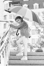 Girl standing on stairs and holding umbrella. Autumn rain. Waiting for bad weather under umbrella. Stylish girl in Royalty Free Stock Photo