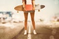 Girl holds Longboard
