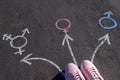 Girl Standing With Transgender, Male And Female Gender Symbols Drawn On Asphalt Road. Overhead view