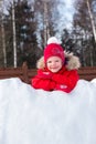 Girl standing by the wall of snow fortress