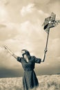 Girl is standing on a wheat field with pinwheel Royalty Free Stock Photo