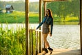 girl standing on a wooden pier .