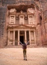A girl stands alone in Petra in front of Al-Khazne spread her arms up Royalty Free Stock Photo