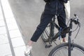 The girl stands on a bicycle. The teenager on the street put her foot on the pedal Royalty Free Stock Photo