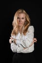 Youth stands on a black background in a white blouse. Joyful smiling at camera, enjoy concept, in studio, business woman, blonde Royalty Free Stock Photo