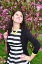 A girl stands at the cherry blossoms Royalty Free Stock Photo