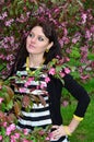 A girl stands at the cherry blossoms Royalty Free Stock Photo