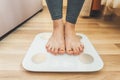 Girl stands on electronic light scales