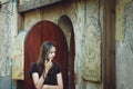 A girl stands at the entrance to the alchemist`s shop in Vyborg