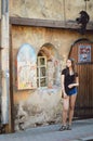 A girl stands at the entrance to the alchemist`s shop in Vyborg