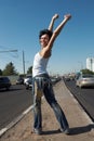 Girl stands in half-turn on middle of road