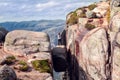 A girl stands on Kjerag stone