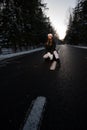 The girl stands in the middle of the road in the winter forest Royalty Free Stock Photo