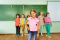 Girl stands near blackboard with numbers