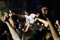 A girl stands over the crowd in a concert at Razzmatazz discotheque Royalty Free Stock Photo