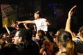 A girl stands over the crowd in a concert at Razzmatazz discotheque