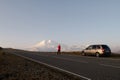 a girl stands on the road and takes pictures of Elbrus Royalty Free Stock Photo