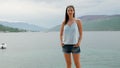 Girl stands at the shore of the Bay in Montenegro