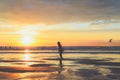 A girl stands at the shore of the ocean school age child playing and splashing sea water at the beach Royalty Free Stock Photo