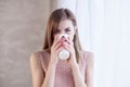 Girl stands at the window with a mug Royalty Free Stock Photo