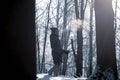 A girl stands in a winter forest on a frosty day. Blue tint