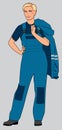 A girl stands in a working blue overalls. Figure in full growth