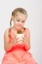 The girl stares at a cactus in pot