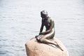 Girl statue sitting on rock