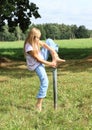 Girl stepping on iron pillar