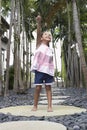 Girl On Stepping Stone Pointing Away Royalty Free Stock Photo