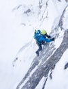 Girl in the storm during an extreme winter climb. West italian A Royalty Free Stock Photo