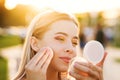 Girl straightens makeup on street Royalty Free Stock Photo