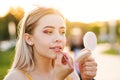 Girl straightens makeup on street Royalty Free Stock Photo