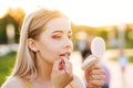 Girl straightens makeup on street Royalty Free Stock Photo