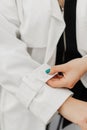 the girl straightens the sleeve of her white coat Royalty Free Stock Photo