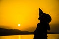 A girl with straw hat enjoy on sunset